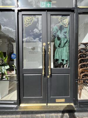 Black glass doors. Use handles to open.