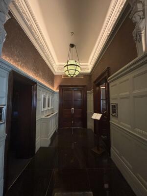 From after main entrance to The Connaught facing right. Hallway ahead to venue entrance at back right.