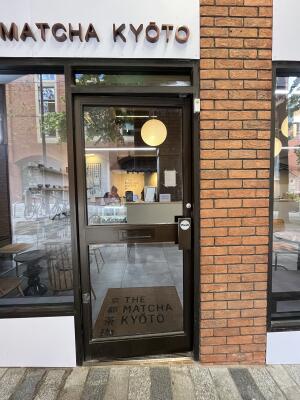 Black metal-framed glass door. Use push plate to open.