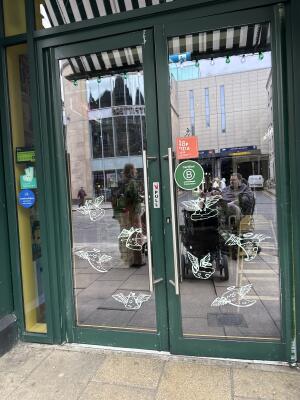 Green metal-framed glass doors. Use handles to open.