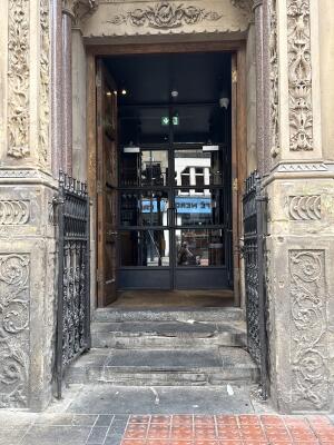 Black metal-framed glass doors. Use handles to open.