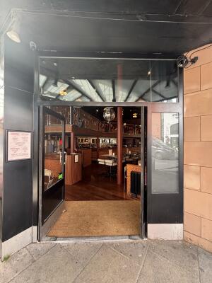 Black metal-framed glass doors. Push handles in centre to open.