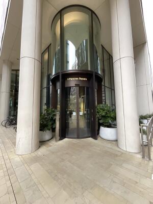 Dark metal-framed glass doors at back. Pillars on left and right.