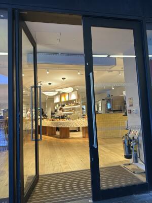 Black metal-framed glass doors. Use handles to open.