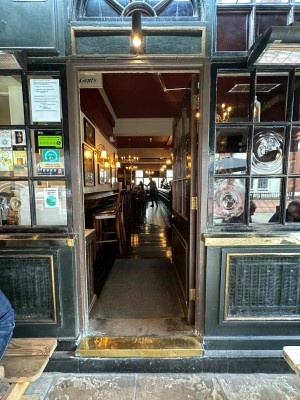 Brown and glass panelled door. Push from left to open.
