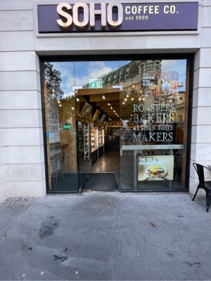 Glass door ahead. One step up before door. Push silver vertical handle on right to open.
