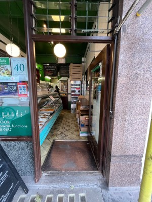 Wood framed glass door. Push from left side to open.