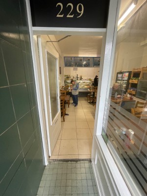 White door with handle at right, push to open.