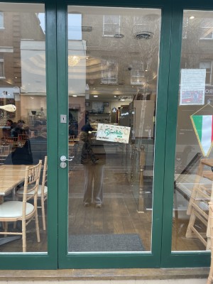 There is step below the door at the entrance. Door is a push door, push from the left side using a handle situated on the left that needs to be pressed down to open.
