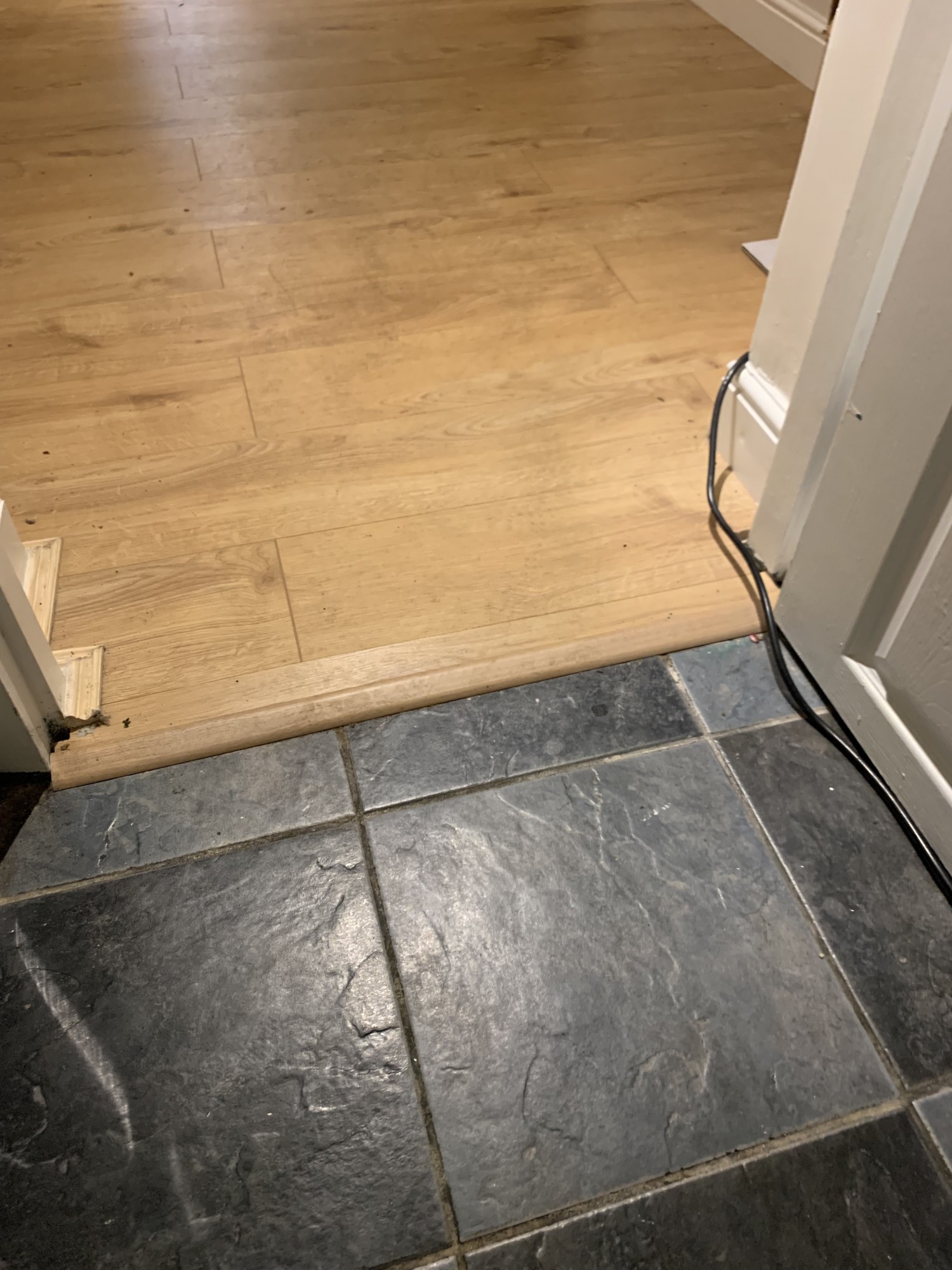 Small bump as part of the entry through the first door to the bathroom.