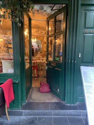 The front door is on the left hand side of the restaurant. It pushes to open. There is a divider on the right as you come into the main area.