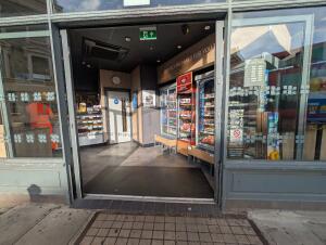 Grey frame glass doors in front. Doors open automatically to the sides.