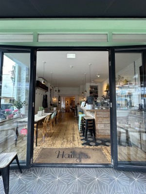 Glass double doors with black doorframe. Pull  from centre to open.