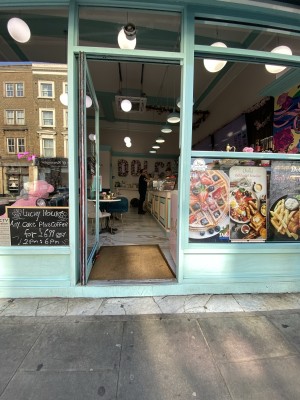 Glass door with white frame ahead. Push from right to open