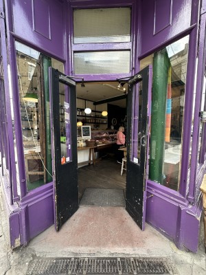 Blue double doors with glass panel ahead