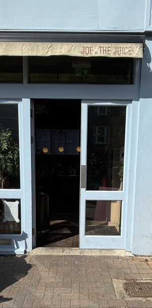 Glass doors with blue frame. Push from center to open.