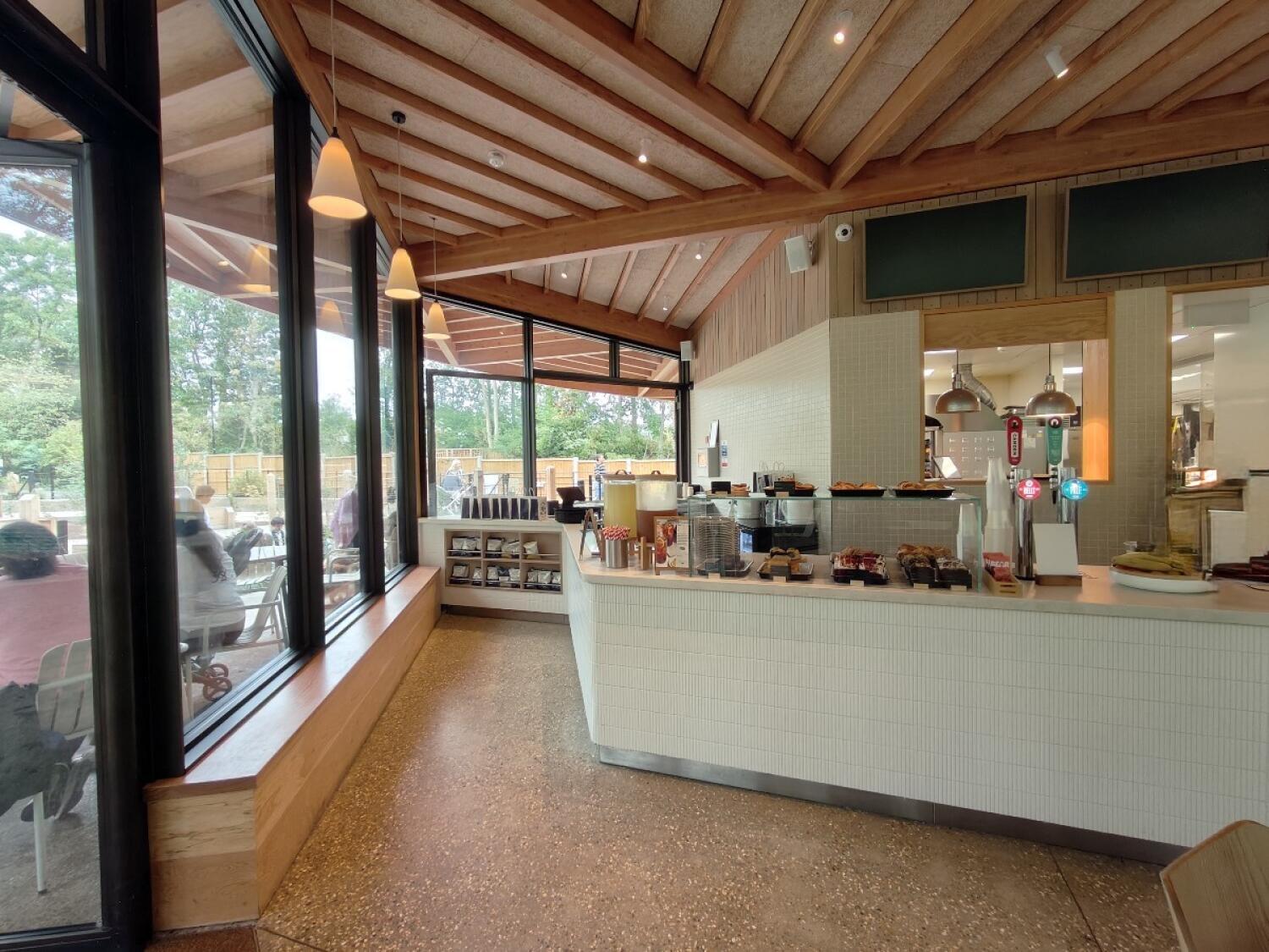 From entrance facing left. Windows and ledge along left. Open floor in centre. Display counter along right.