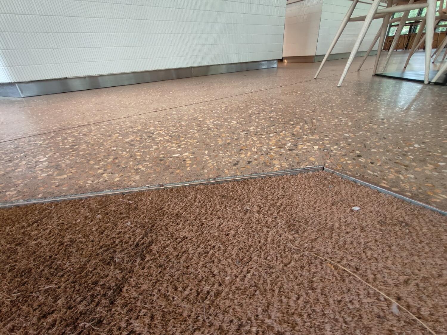 Doormat before threshold. Small bump onto stone floor.