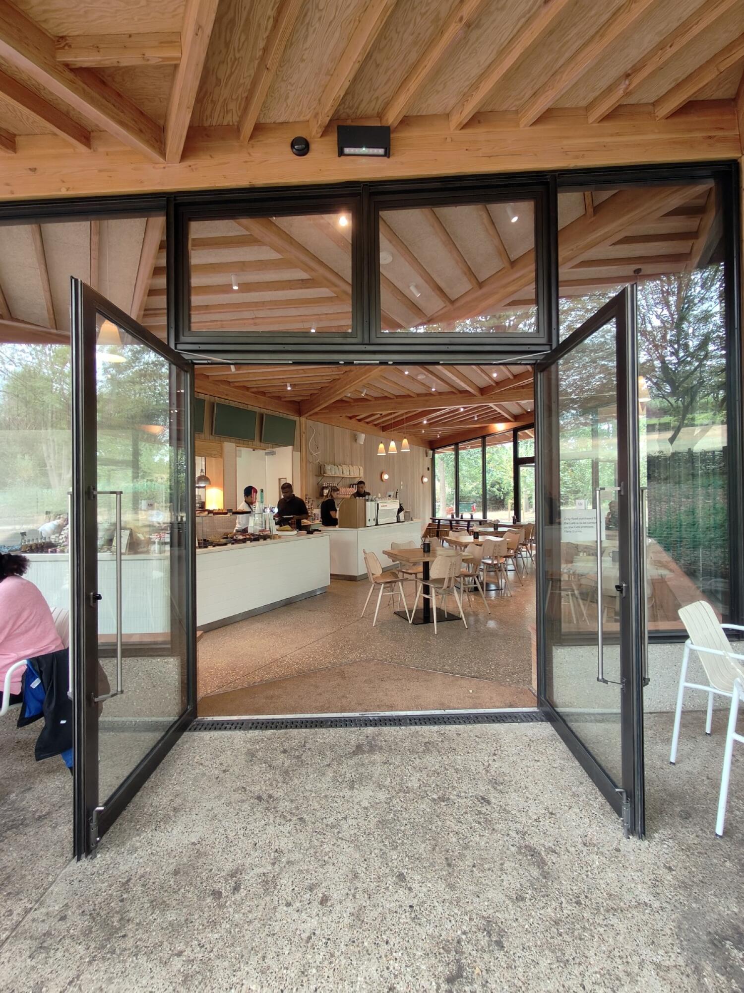 Black metal-framed glass doors. Use handles to open.