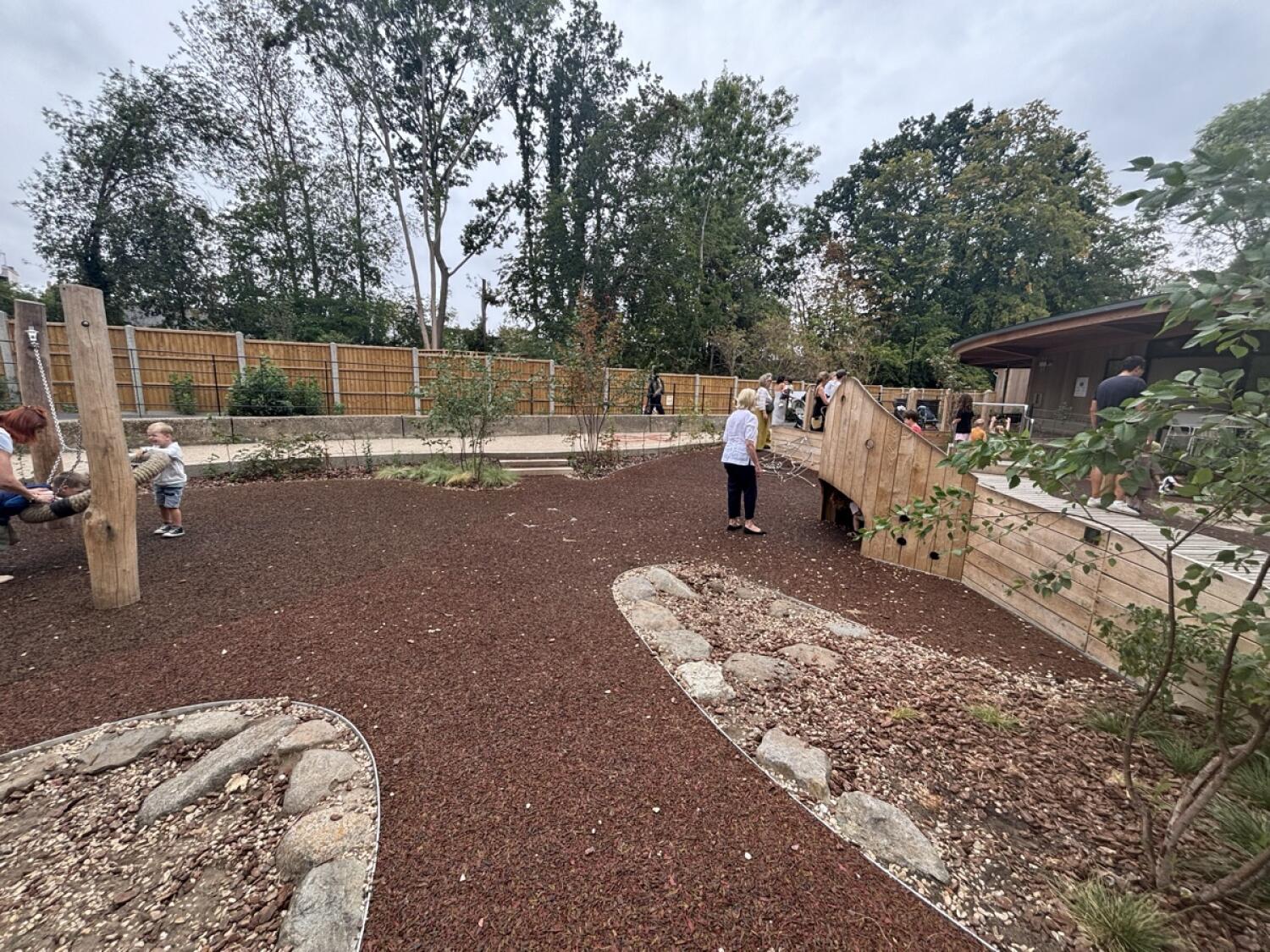 From after plant beds facing right. Gravel play area on left and right. Play area with bark surface at back right.