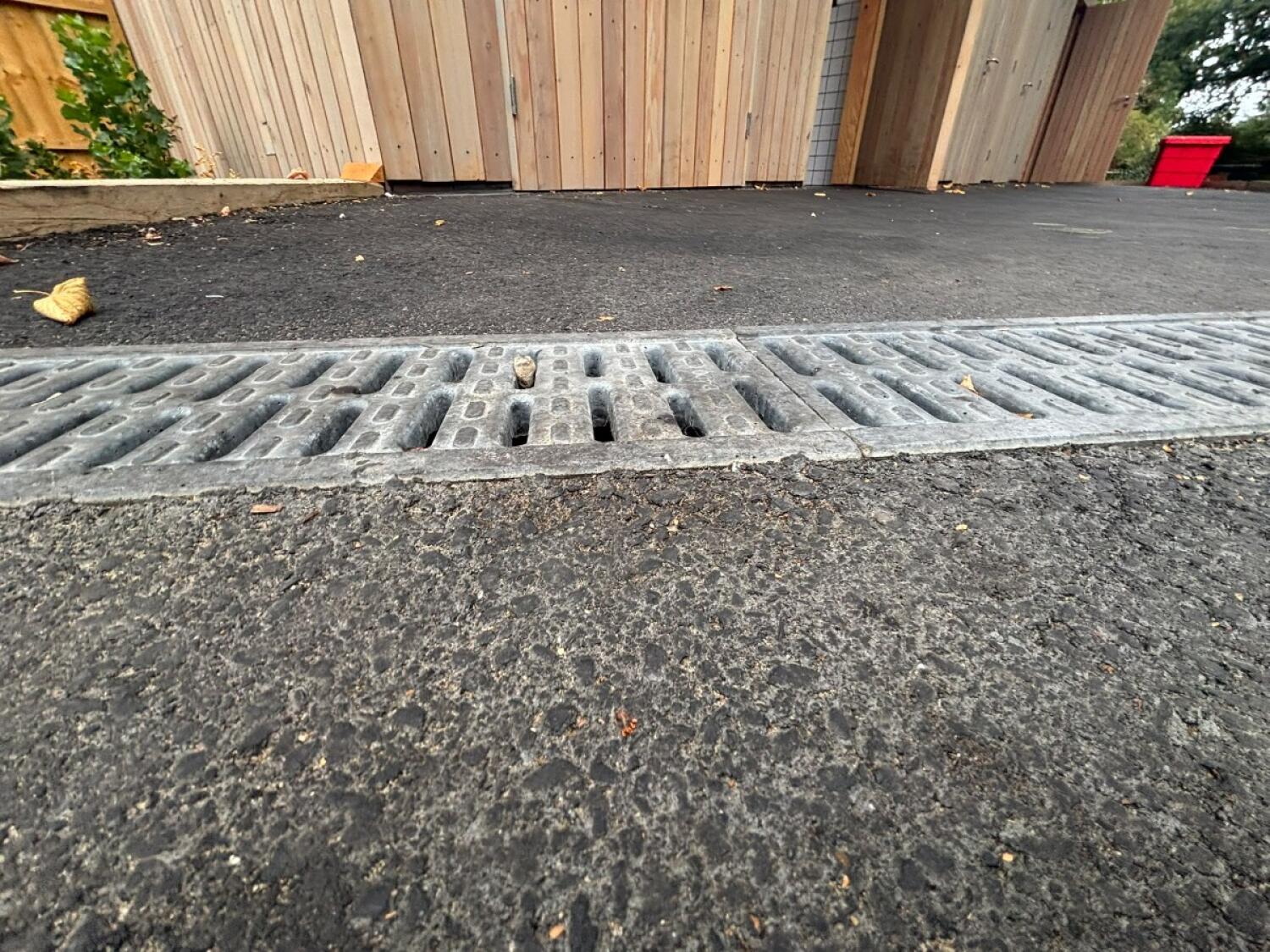 Drainage grate before door. Small bump at threshold.