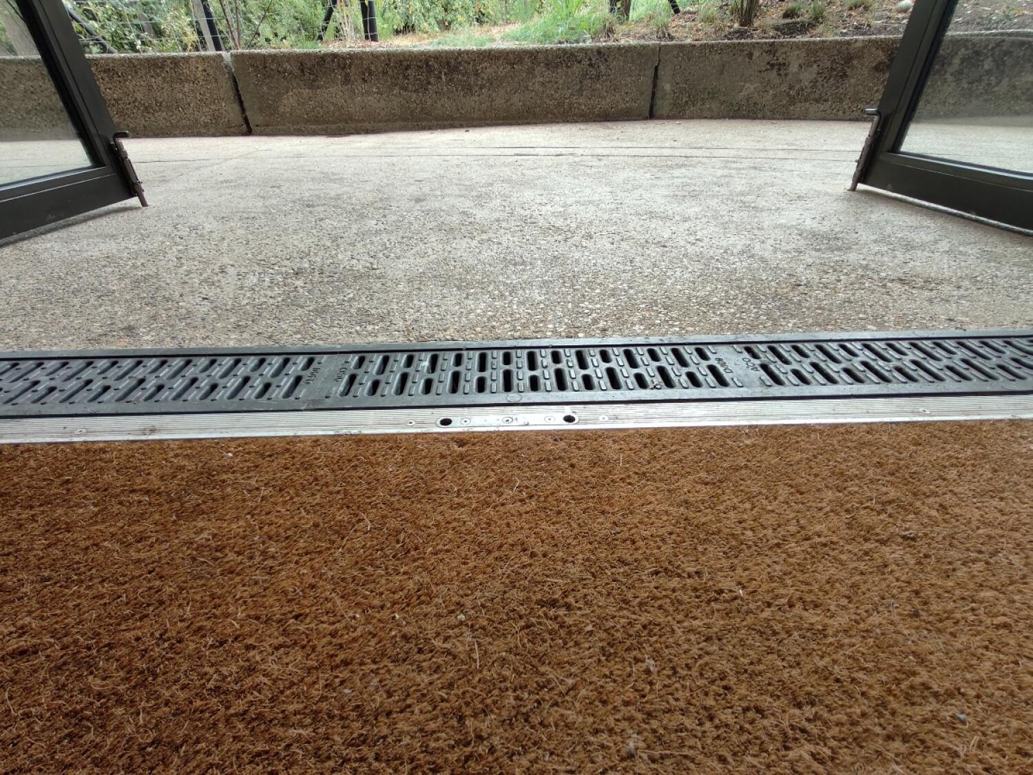 Doormat before door. Small bump at threshold.