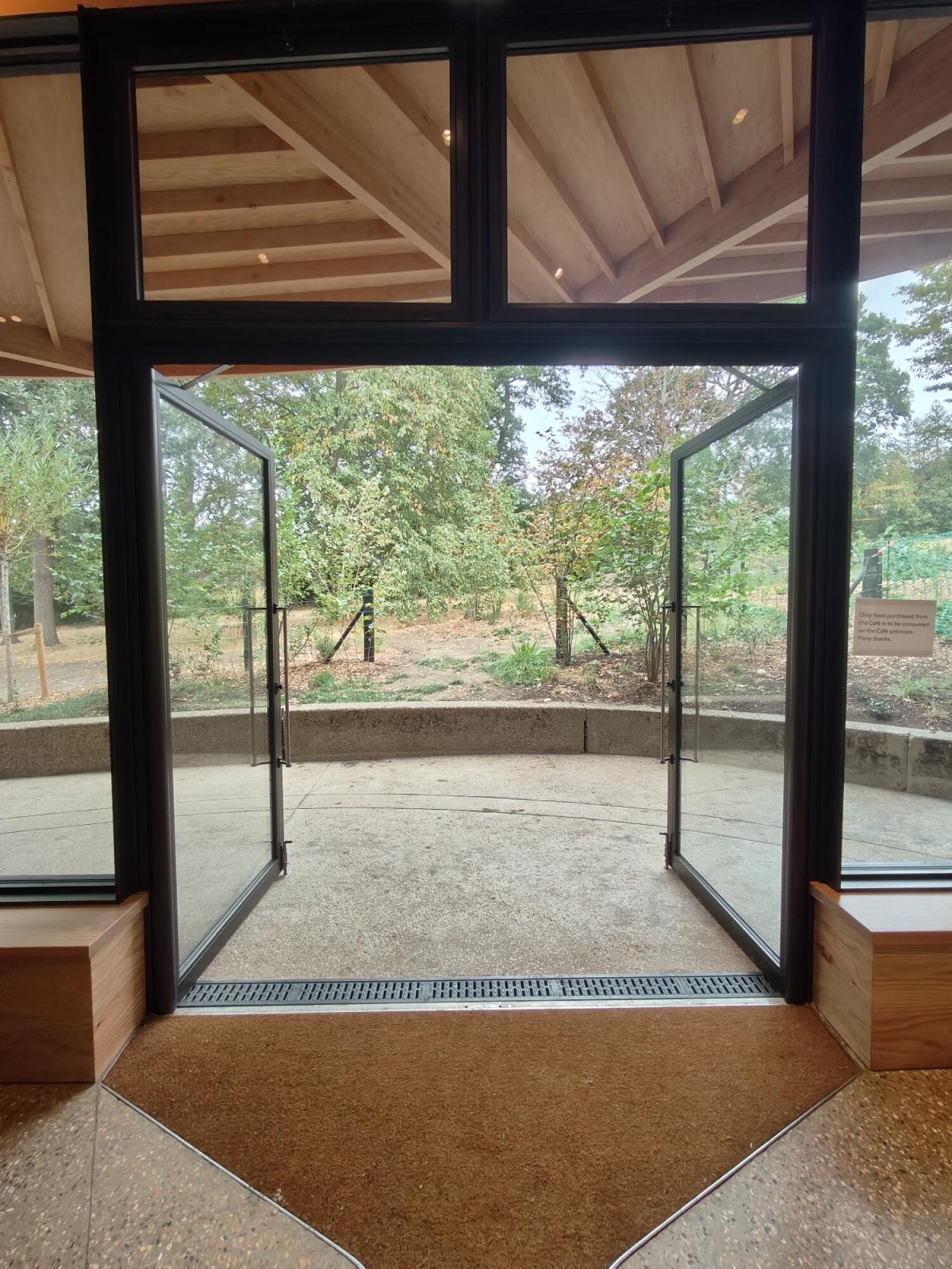Black metal-framed glass doors. Use handles to open.