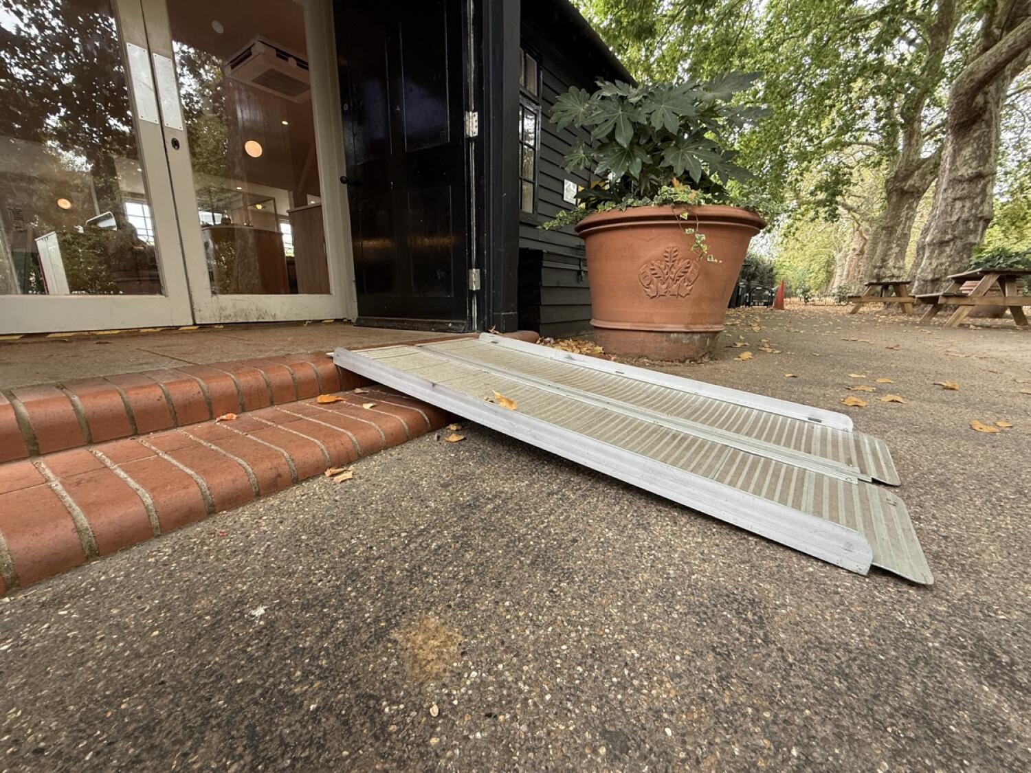 Portable ramp over two steps before door.
