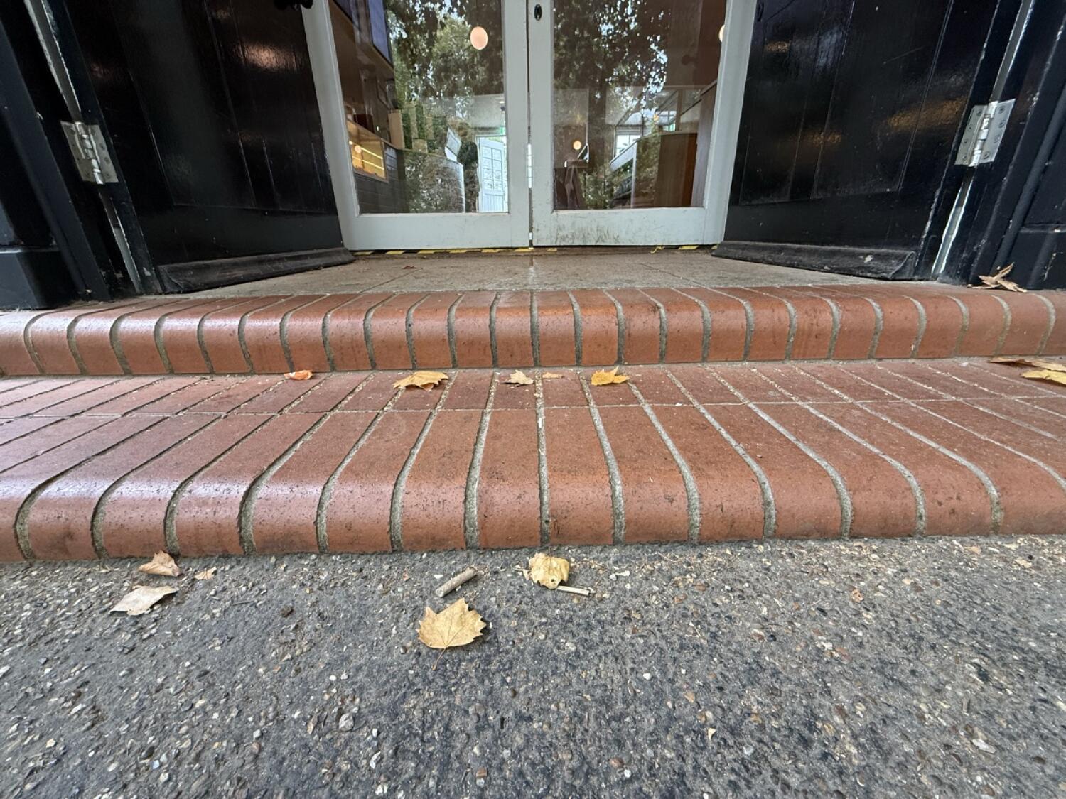 Two steps up before door.