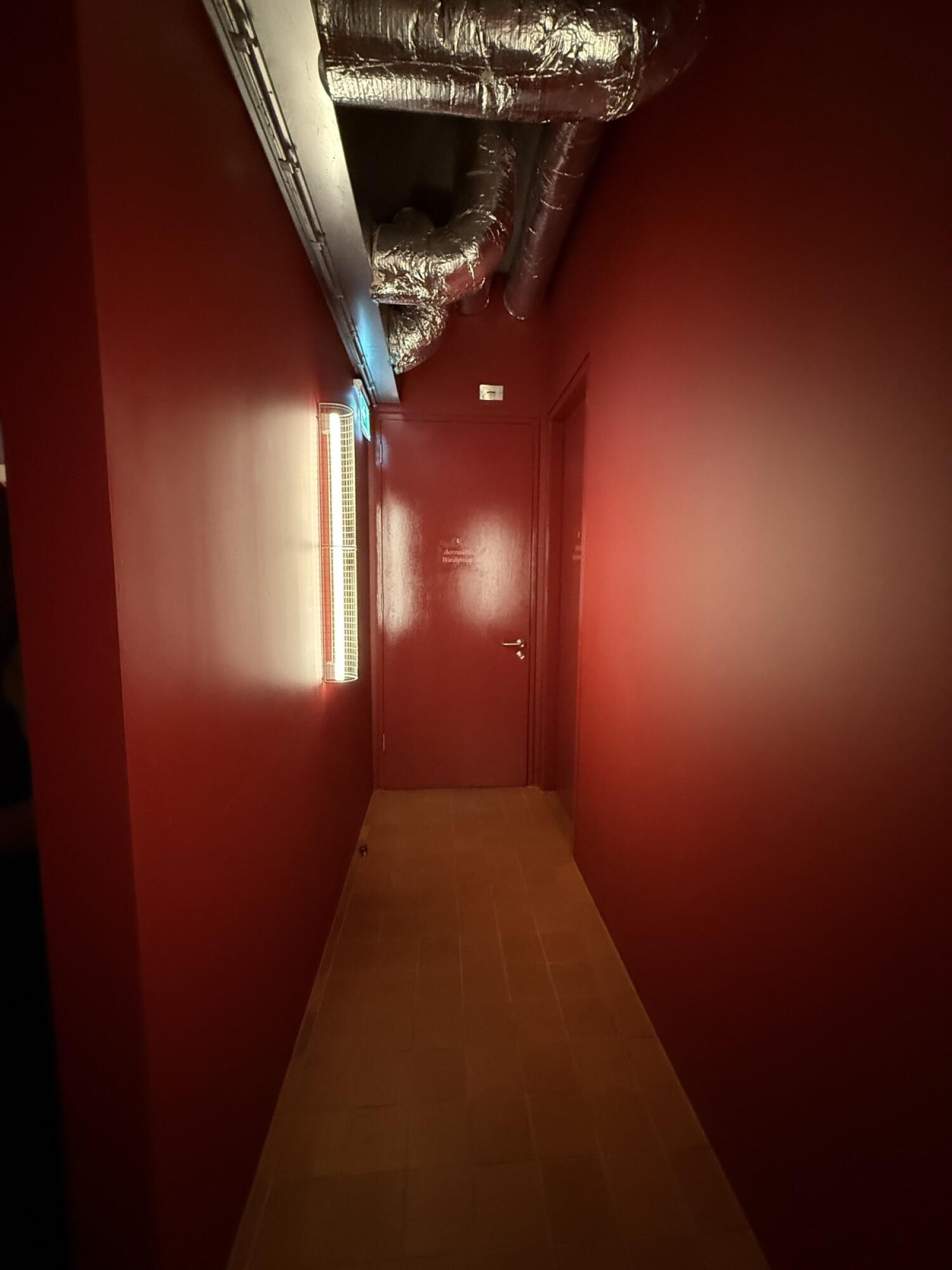 Door ahead at end of corridor.