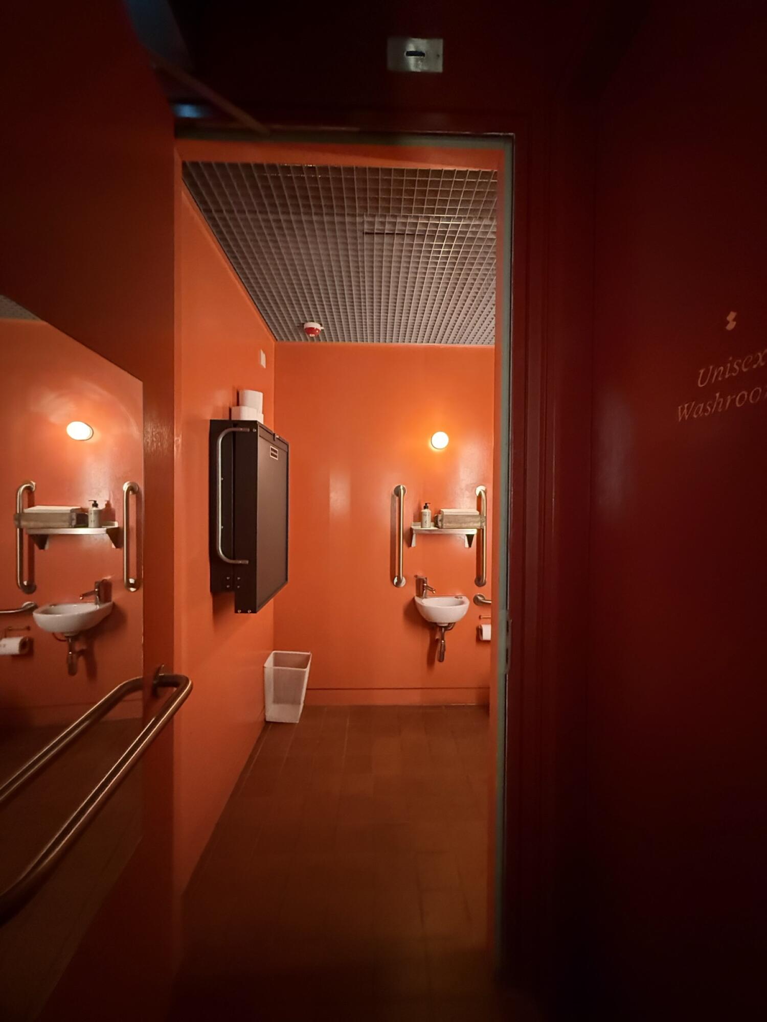 Baby changing station on left wall. Sink on right wall.