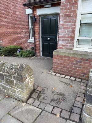 Black wooden door. Use knob to open.