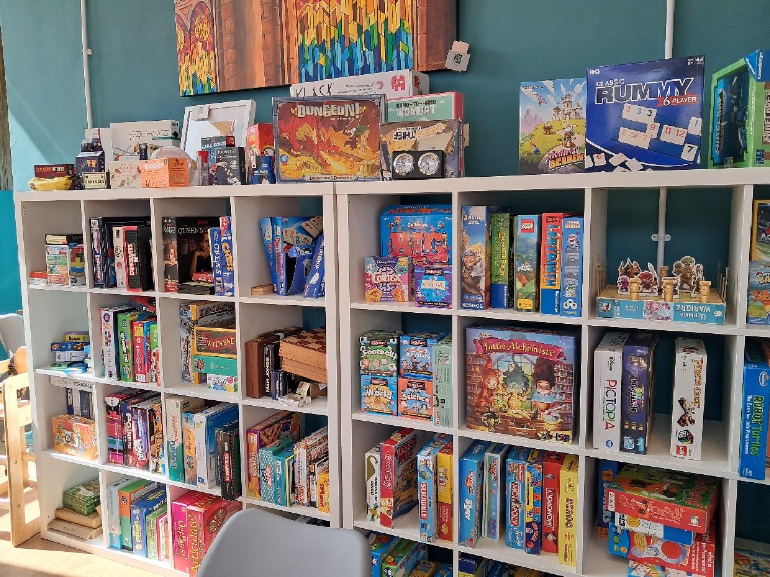 Product shelves cover the wall. Chair in foreground.