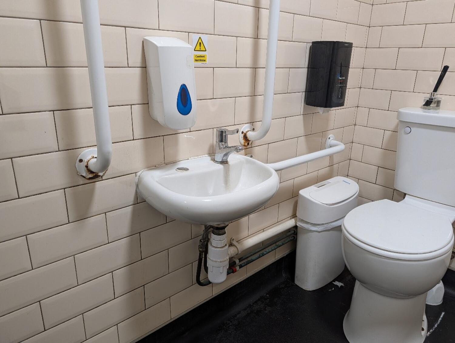 Sink on left wall. Toilet on right.