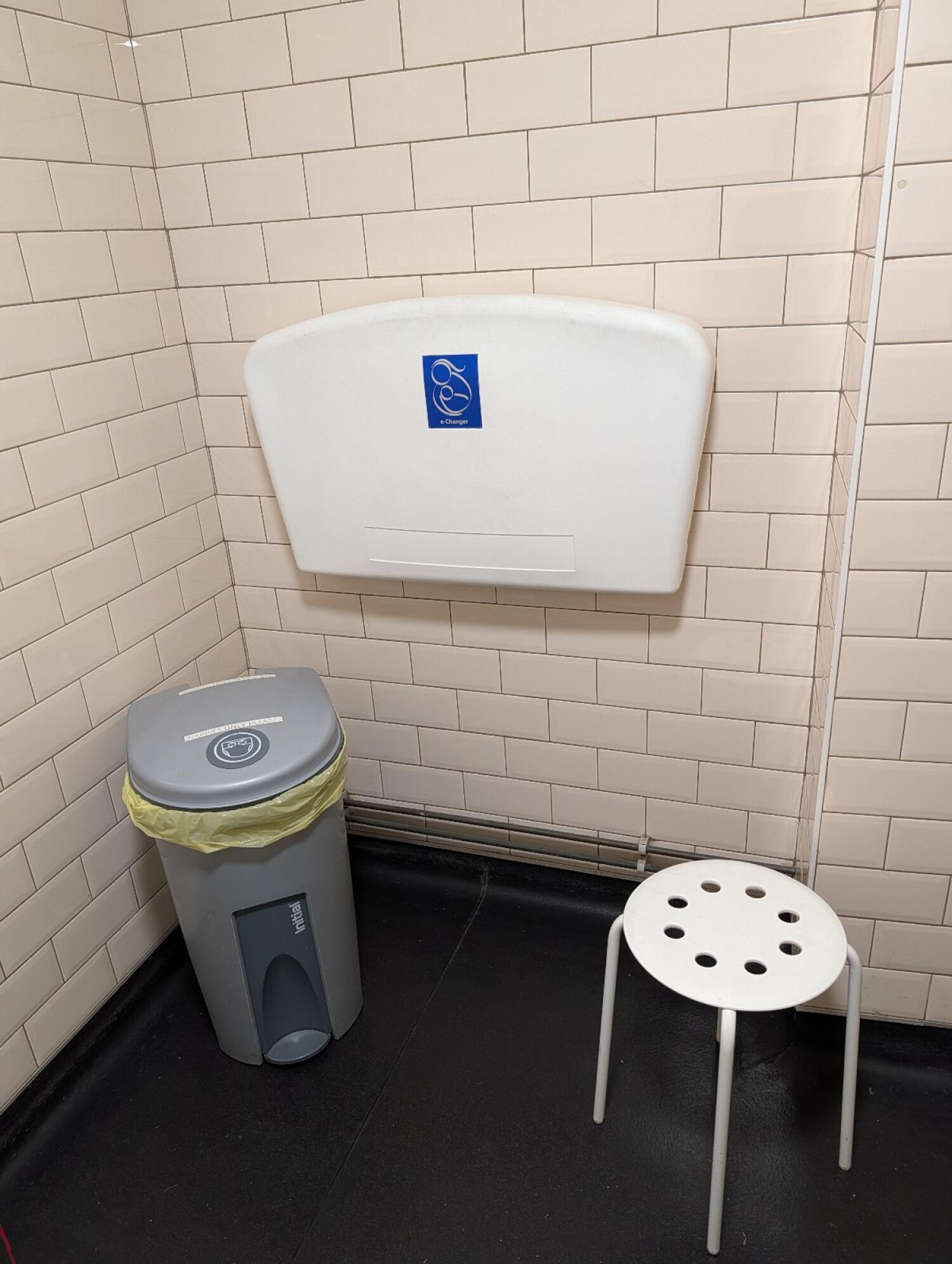 Baby changing station on back wall.