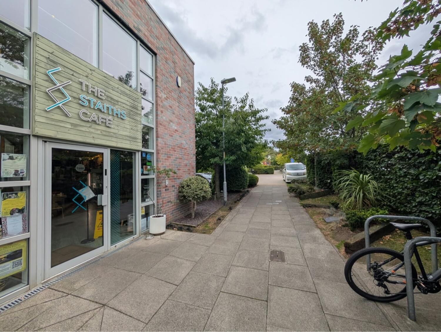 Cafe entrance on left beside paved path.