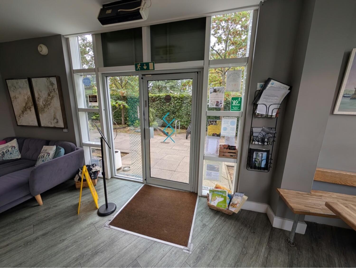 Grey metal-framed glass door. Use handle to open.
