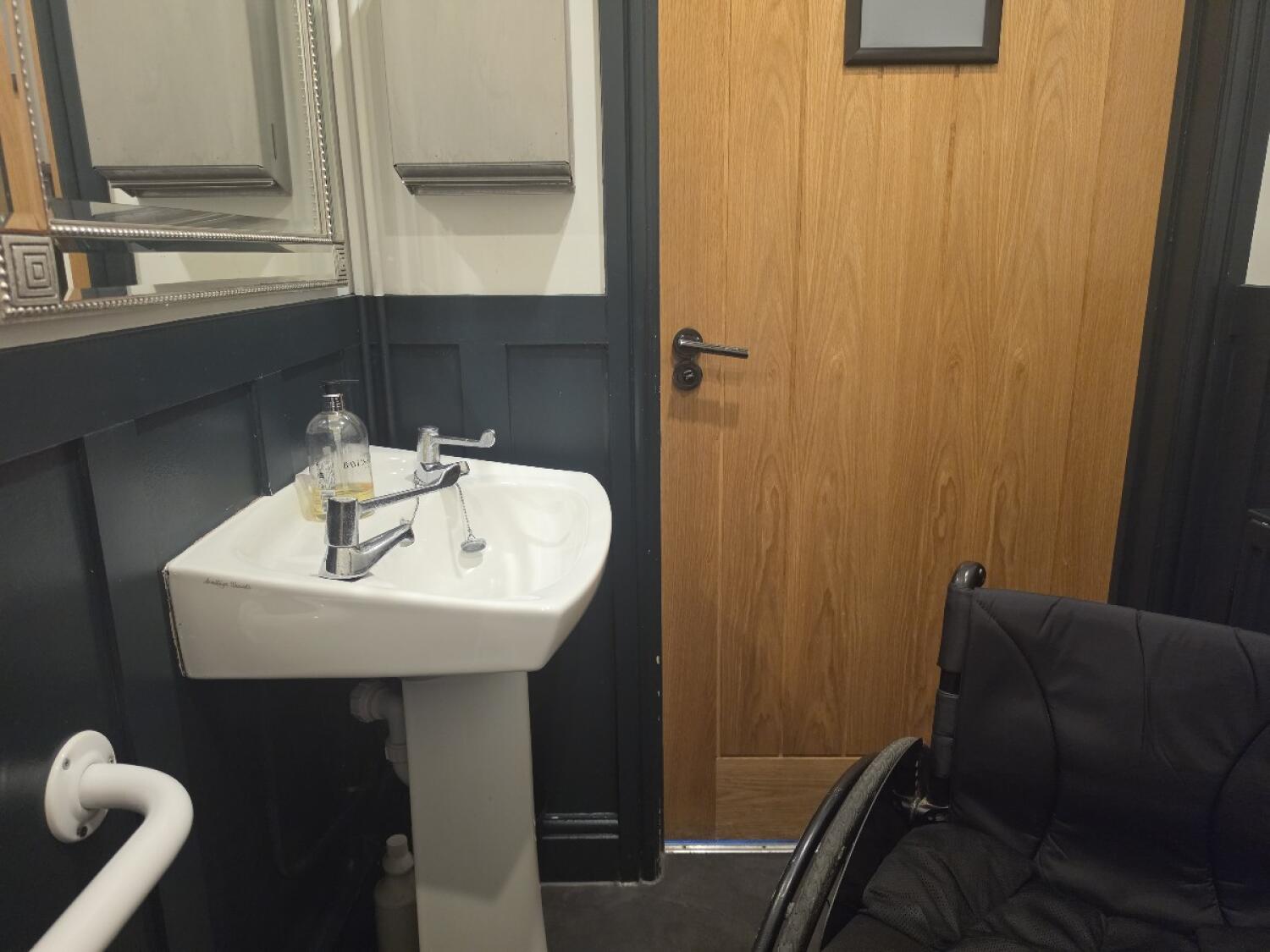 Sink on left wall. Door ahead.