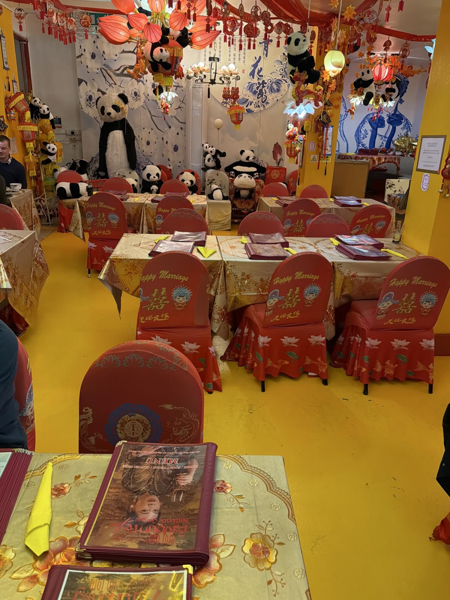 Tables and chairs on left. Clear path through centre. Tables and chairs on right.