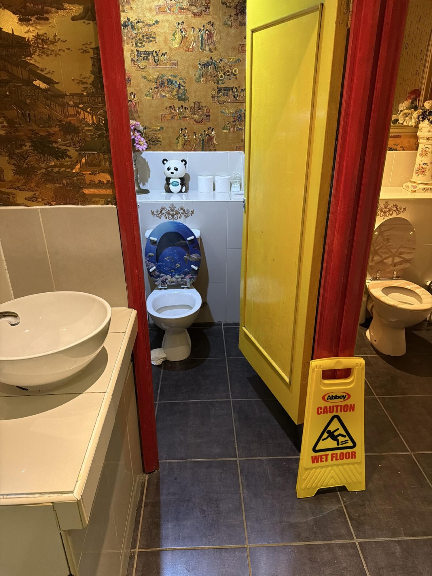 Sink on left. Toilet at back wall centre. Toilet on right.