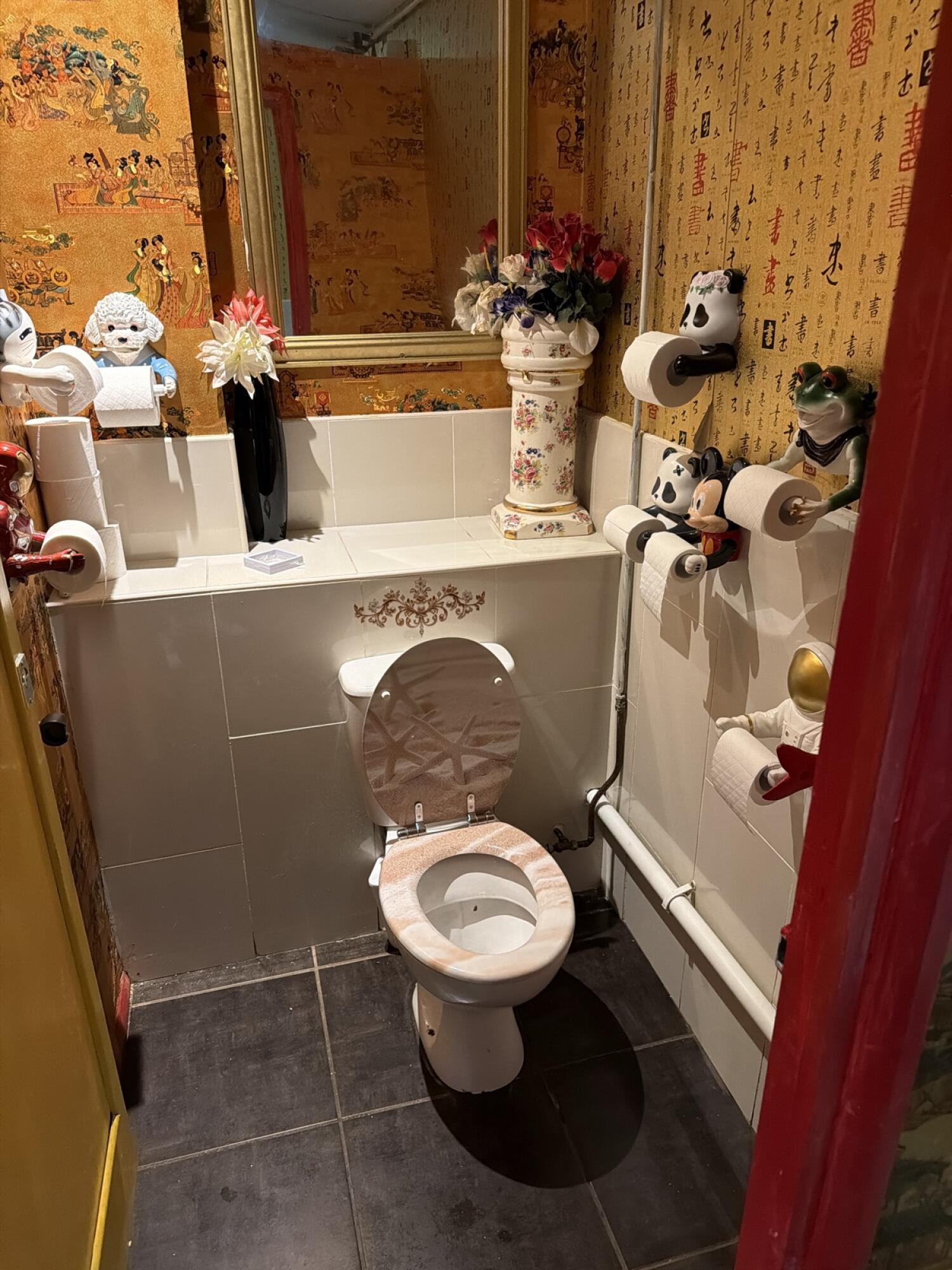 Toilet in centre against back wall.