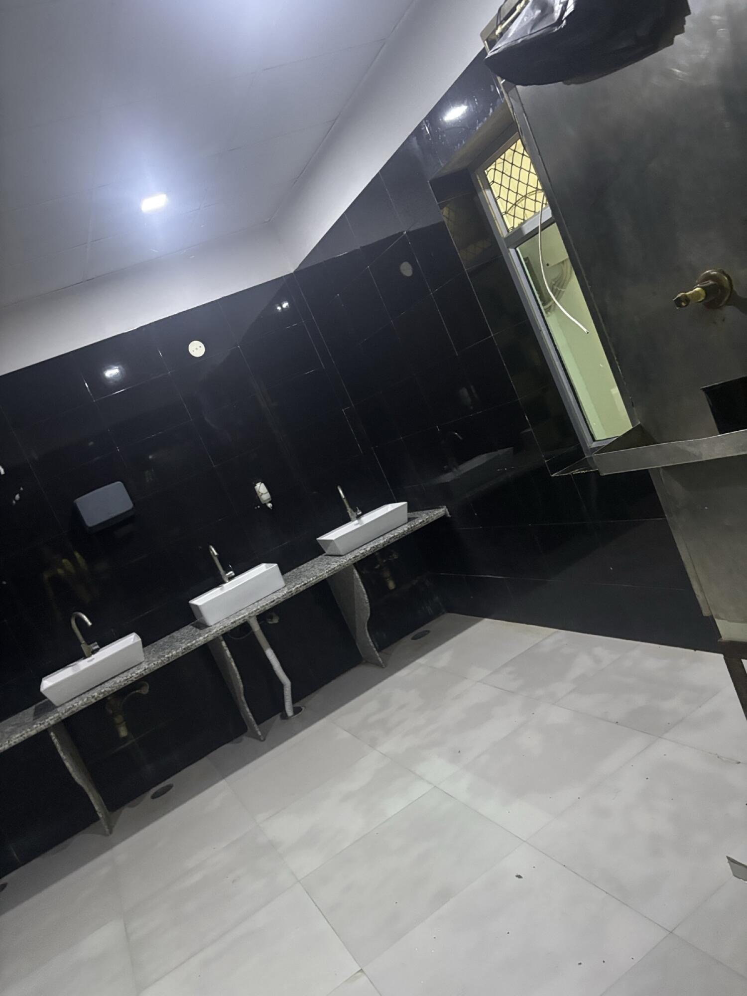 Three sinks along left wall.