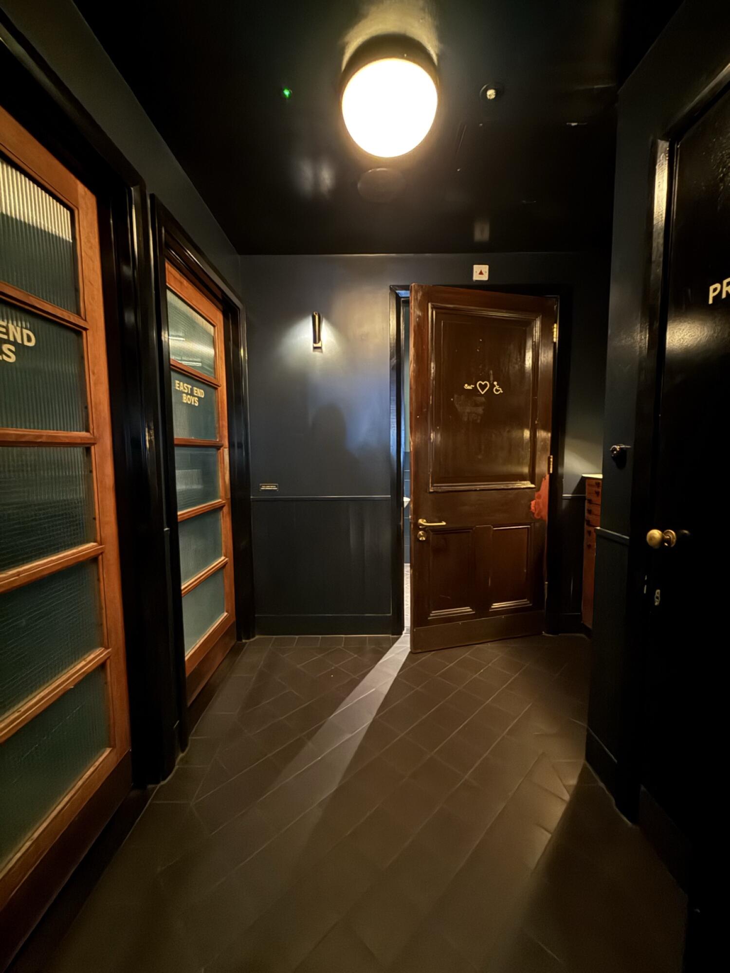 Open door ahead, doors along left and right.