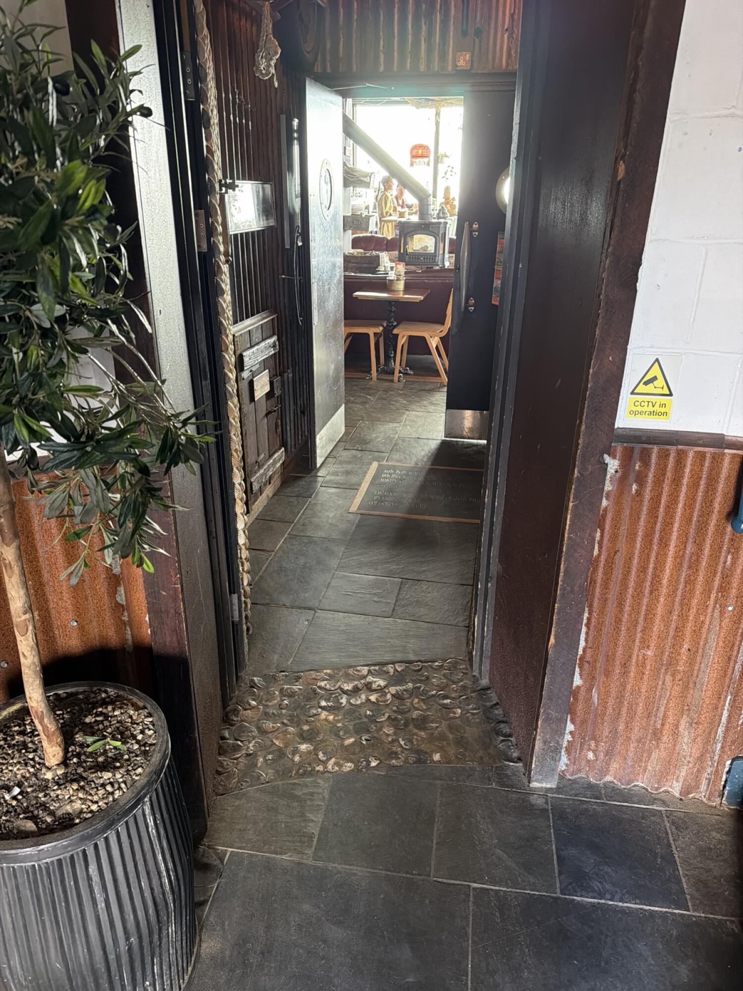Black wooden door. Use handle to open.