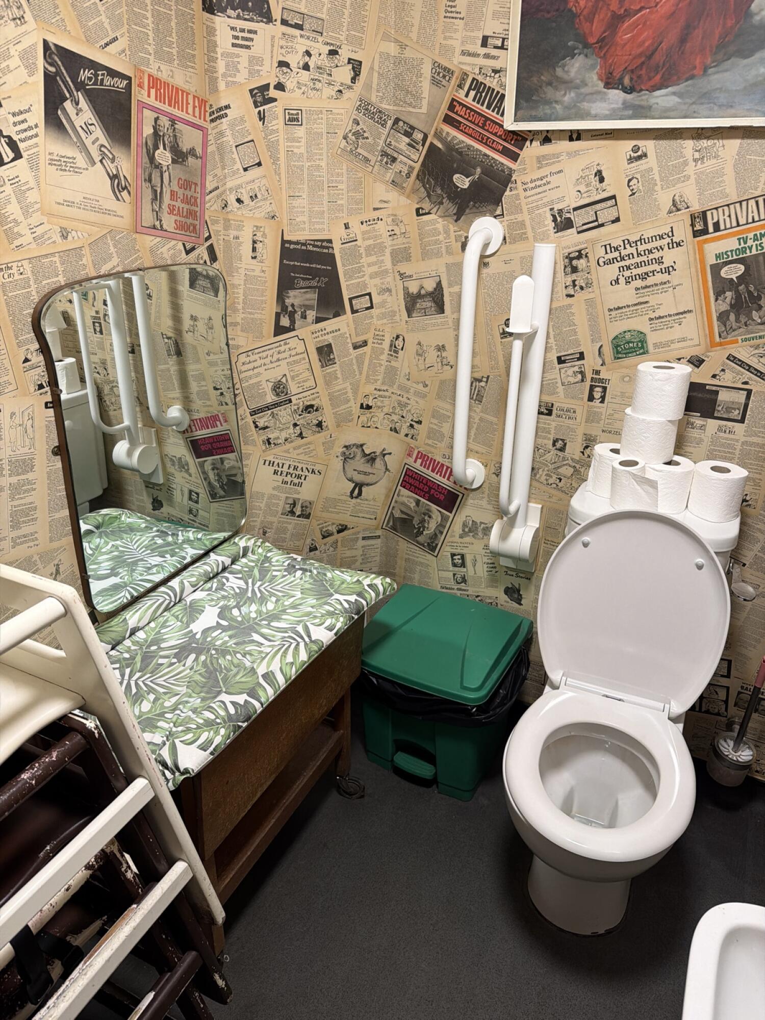 Baby changing station on left. Toilet on right. Sink at front right.