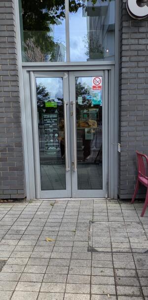 Grey metal-framed glass doors. Use handles to open.