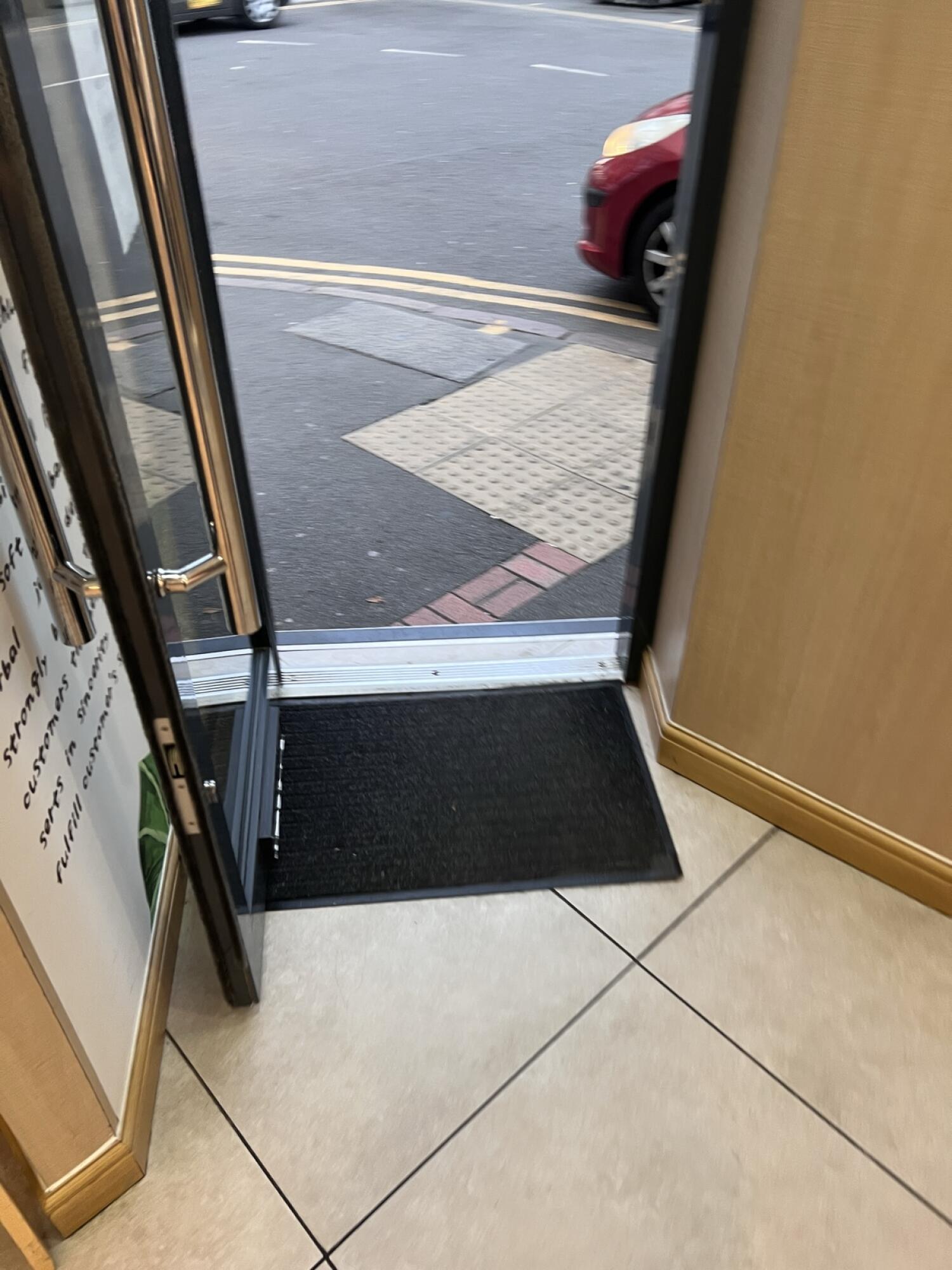 Doormat before door. Small bump at foot of door.