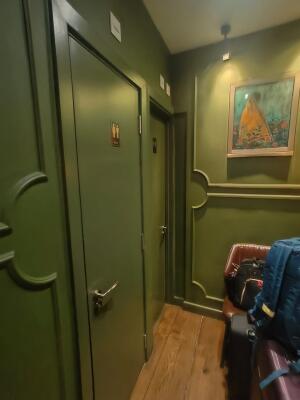 Green painted wooden door. Use handle to open.