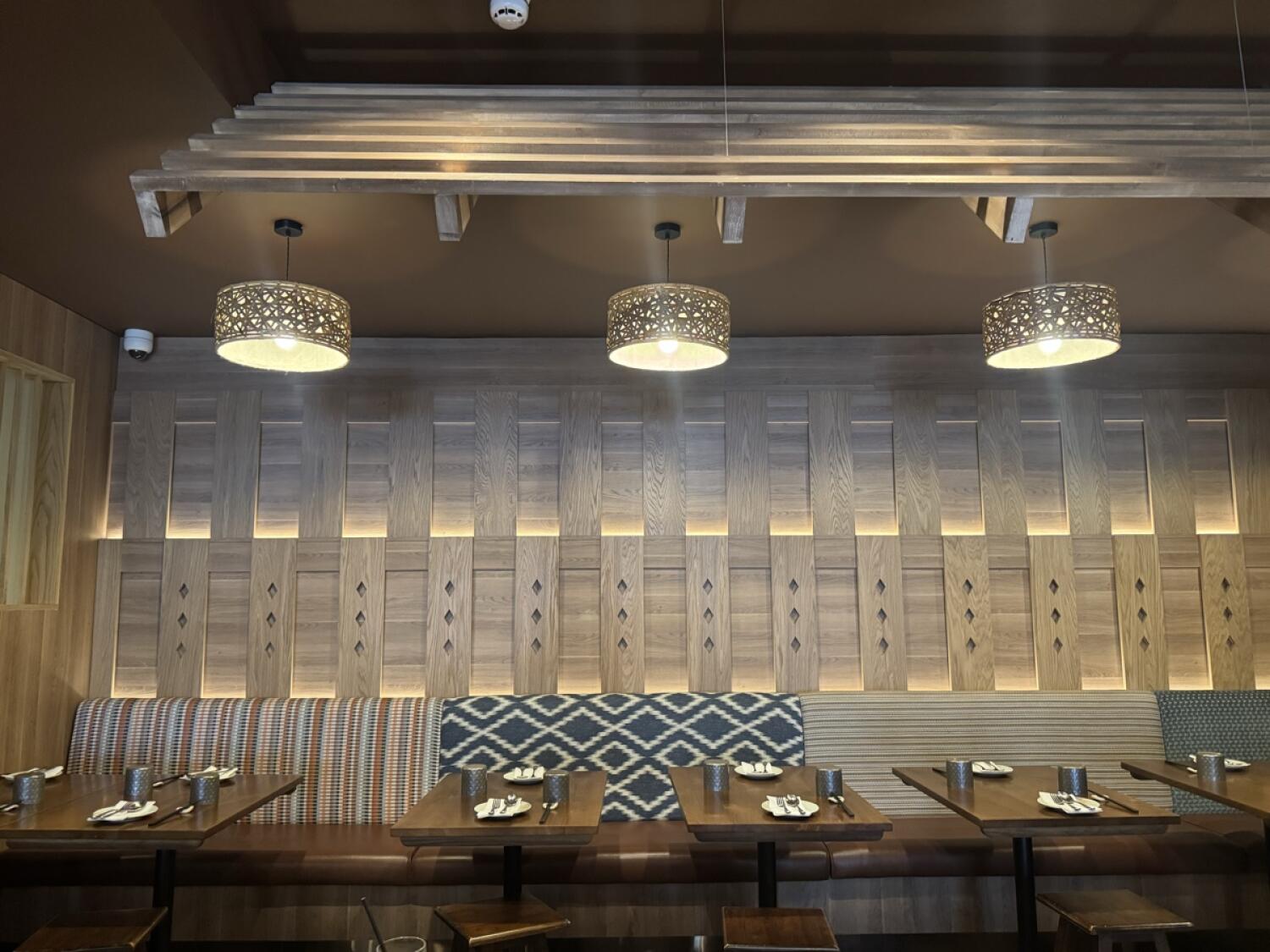 Half booth along back wall. Tables and chairs in front.