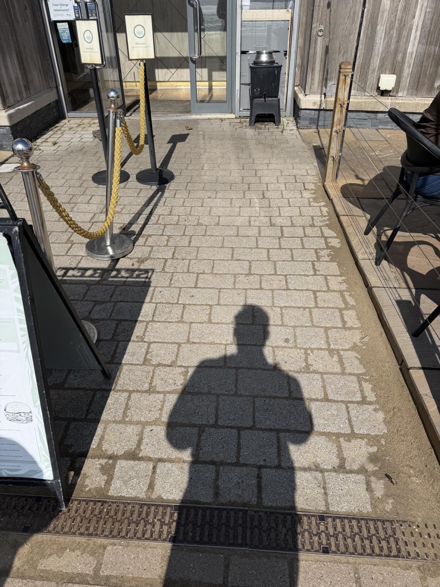 Glass doors ahead at end of paved path.